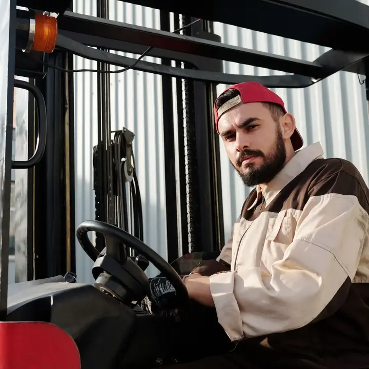 A forklift driver looking out from the cab.