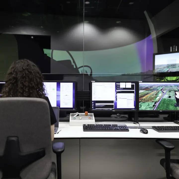 An operations controller at a multi-screen dispatch desk.